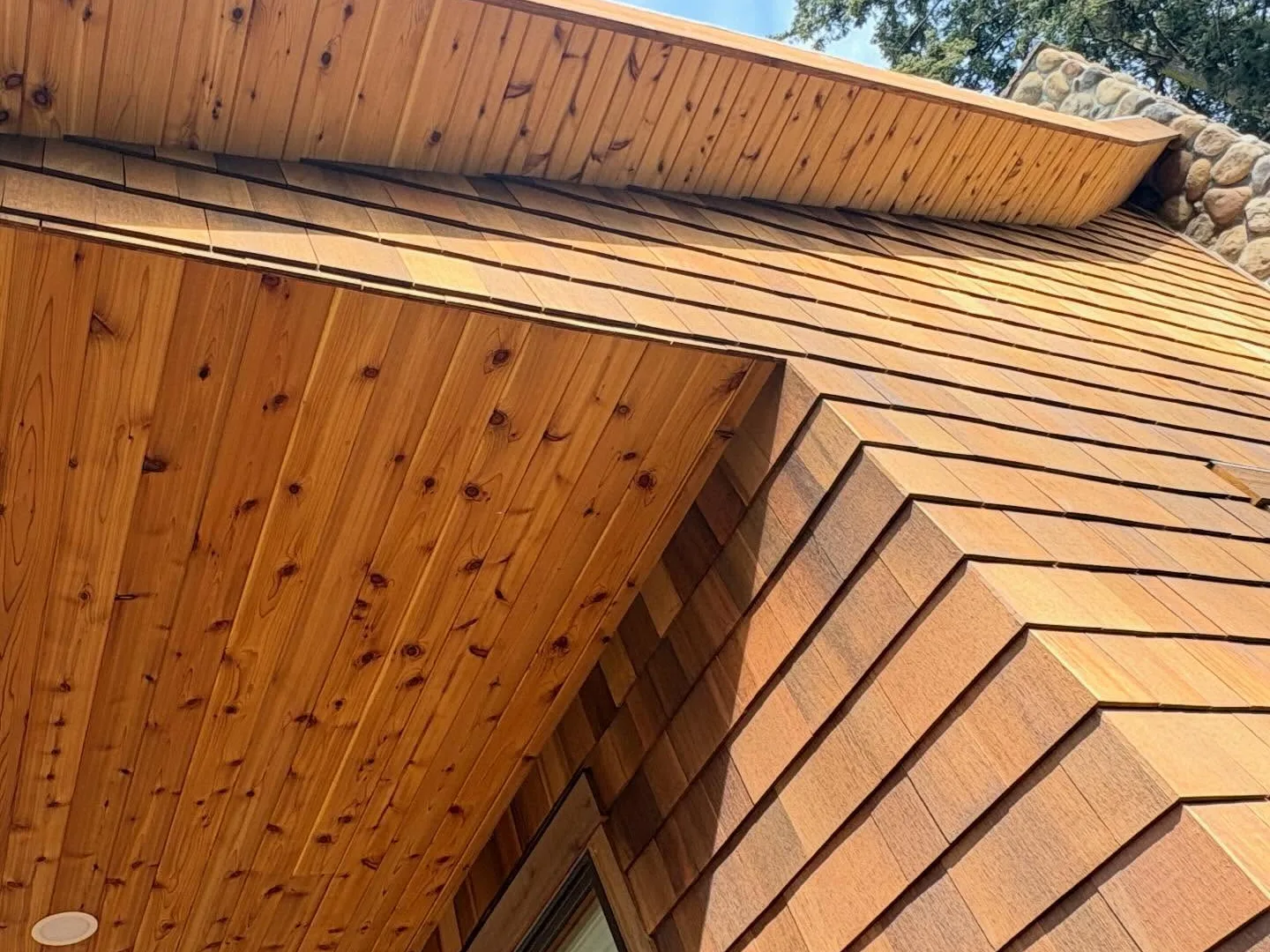 Cedar shingle siding meeting a cedar soffit at a gable