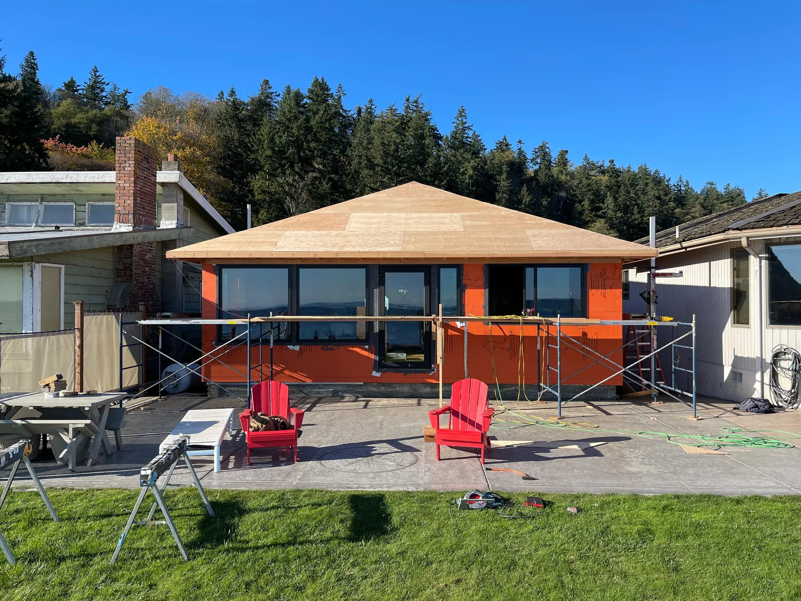 Cottage remodel with new windows, new roof sheathing and house wrap