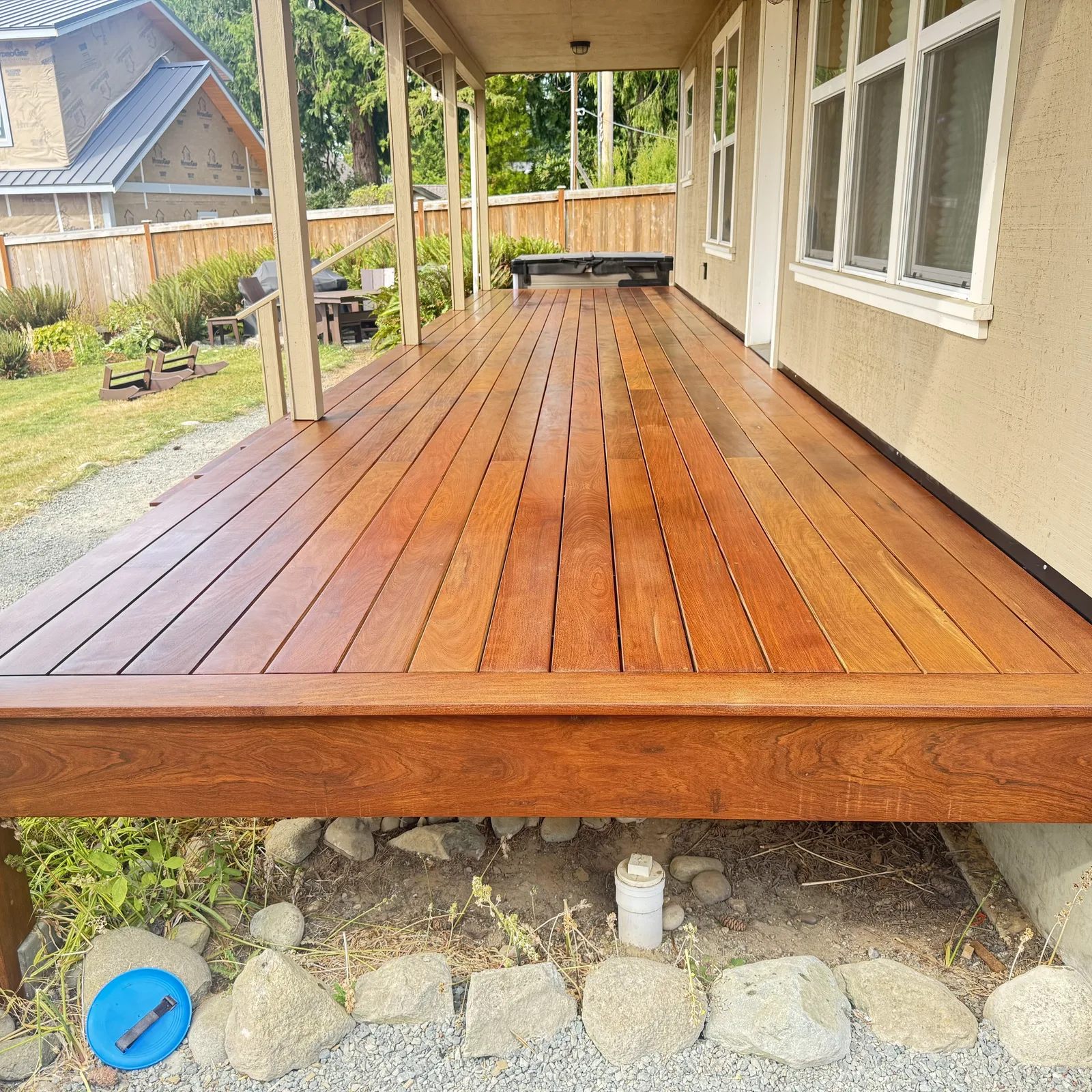 Covered ironwood deck beneath a custom home