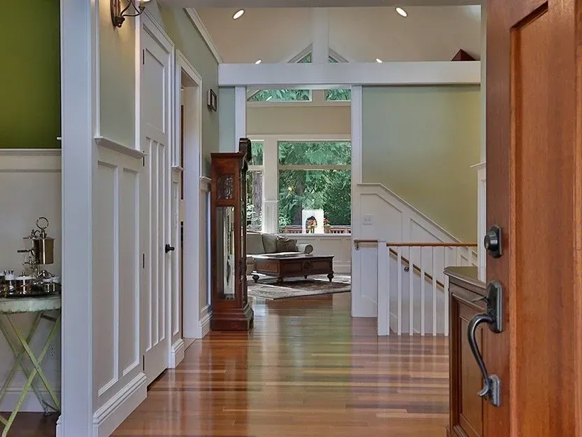Entry hall of a custom home with white wainscoting and wood floors