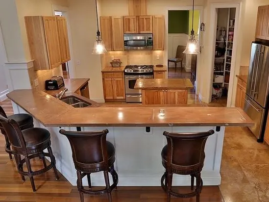 Kitchen bar counter with stools in a custom home
