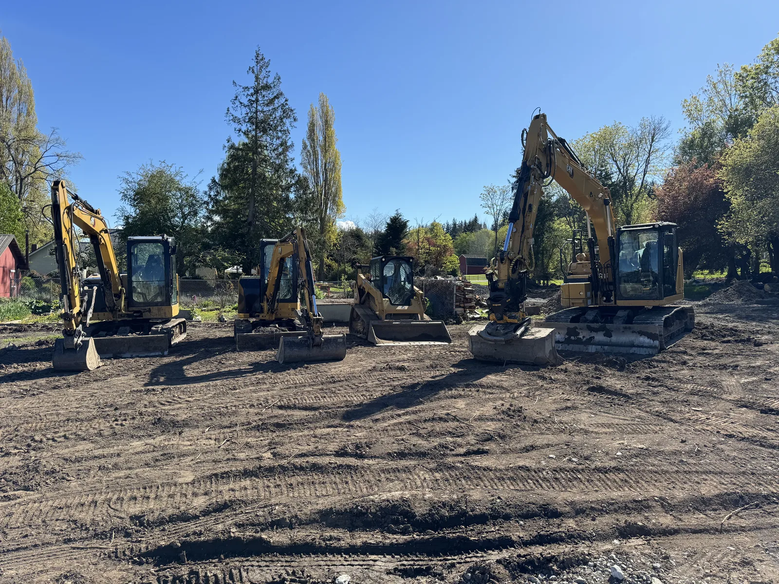 Two excavators on a freshly graded building site on Whidbey Island