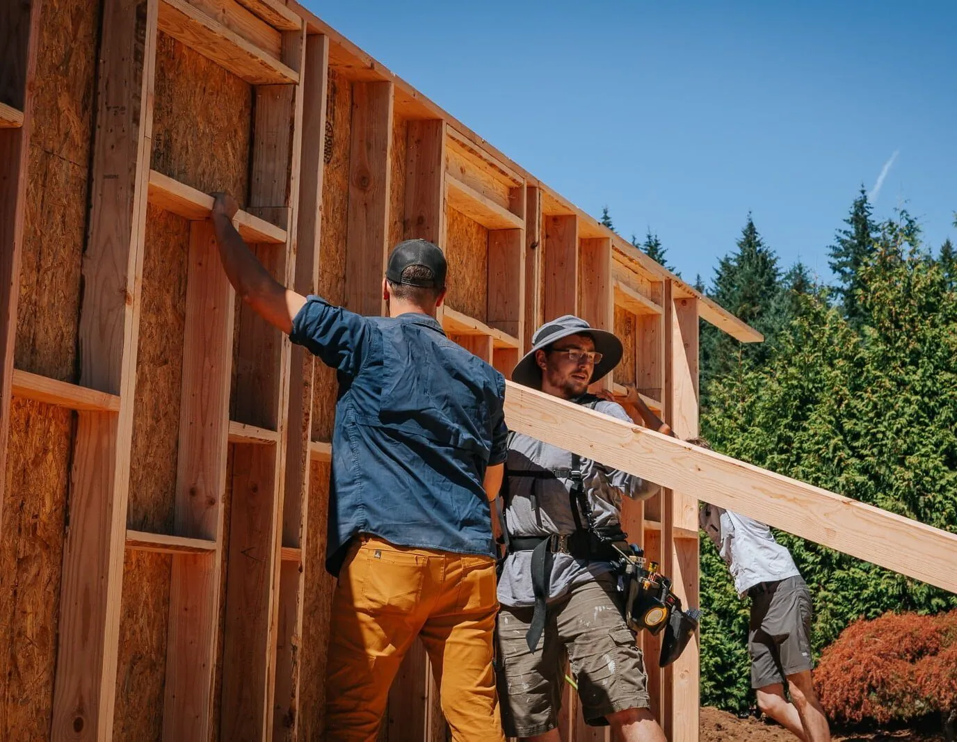 Framers raising a wall panel for a home addition