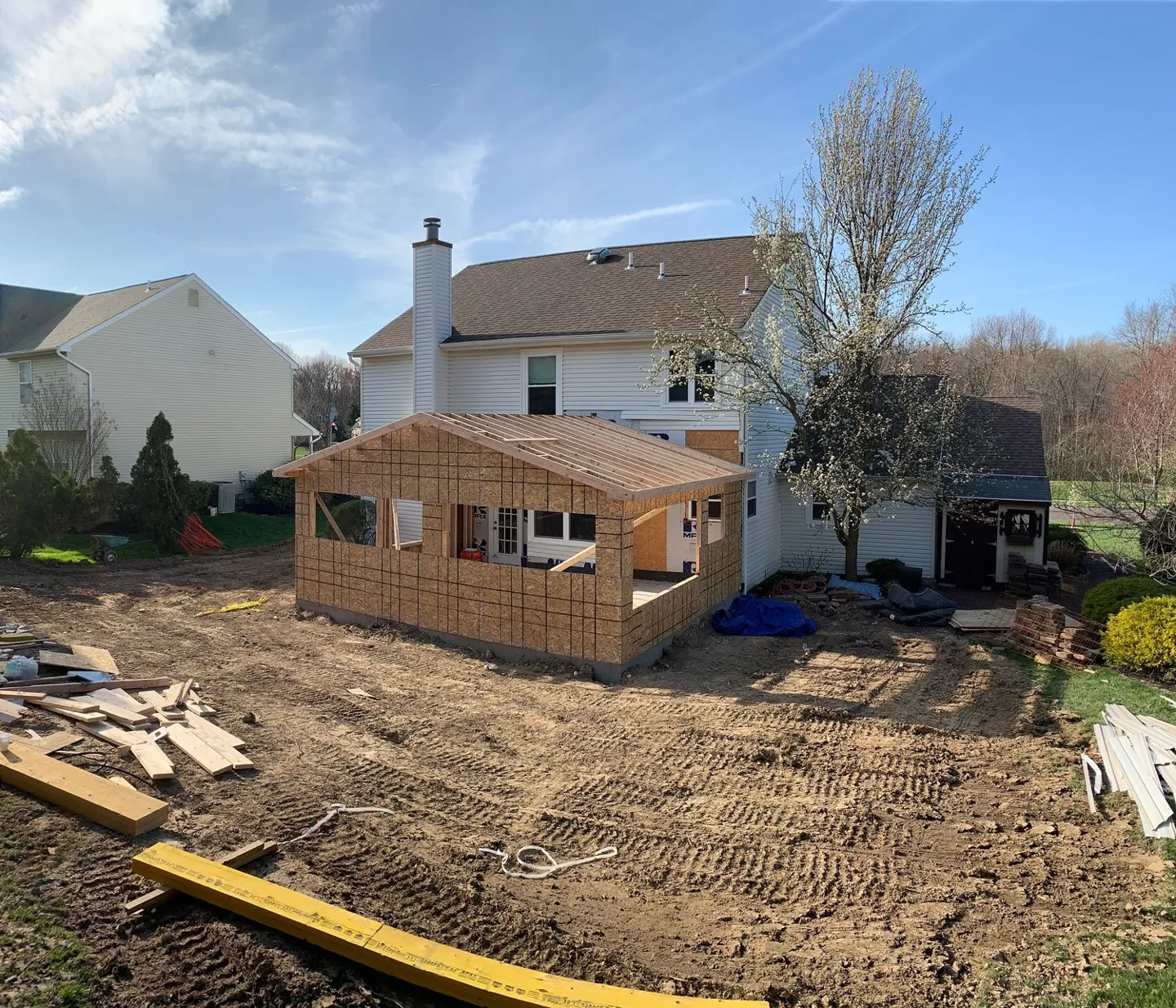 Home addition framed and sheathed off the back of a two-story house