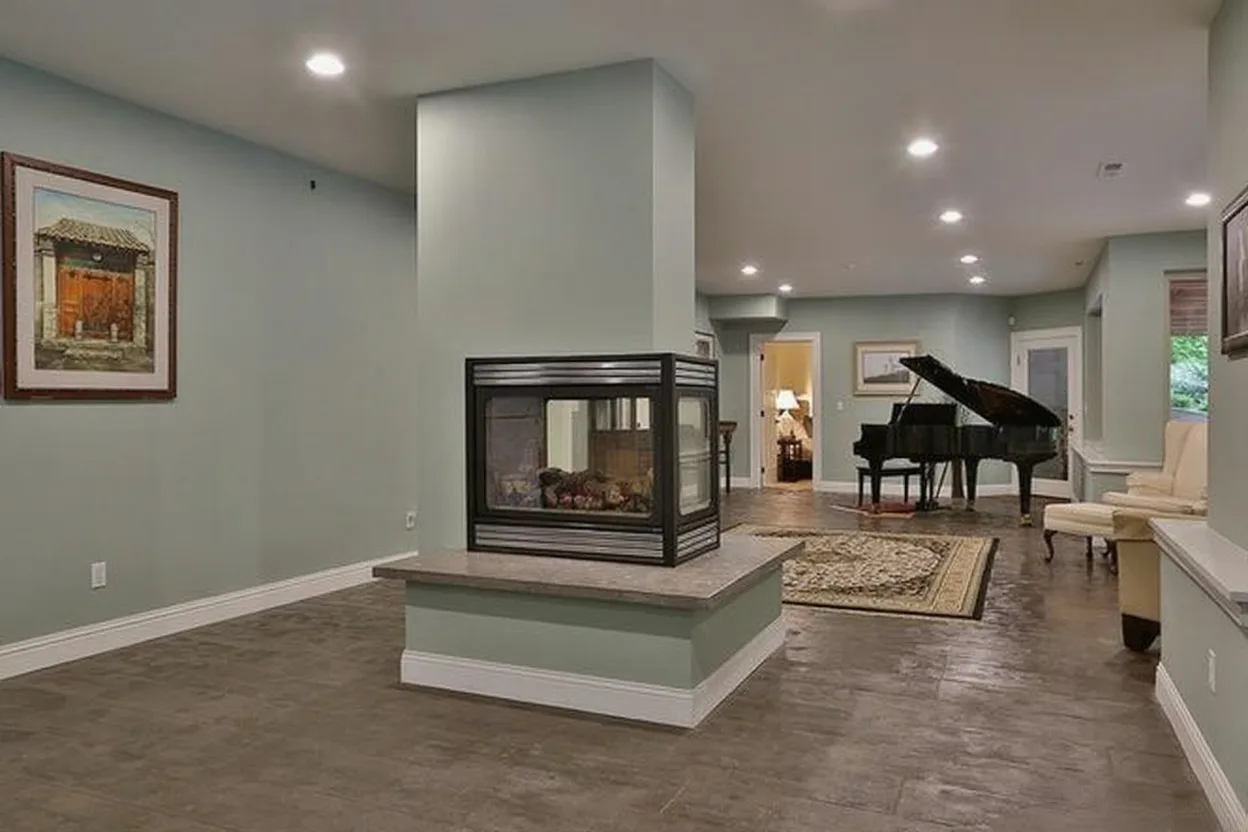 Remodeled great room with a double-sided fireplace and tile floor