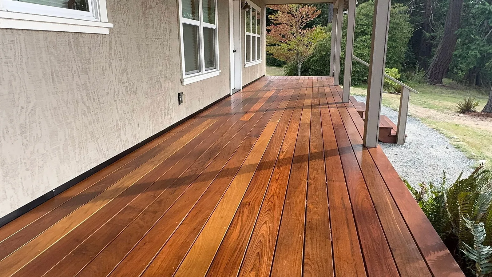 Long ironwood deck run along a house with a covered section