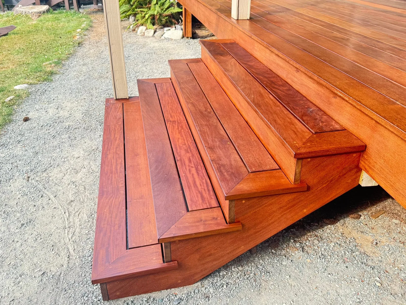Ironwood deck with picture-framed stairs down to a gravel path