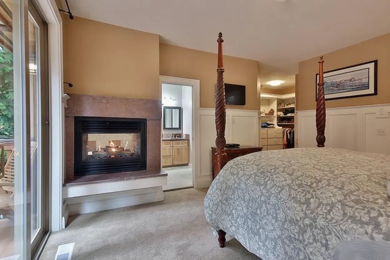 Remodeled bedroom with a tiled fireplace surround and built-in cabinetry